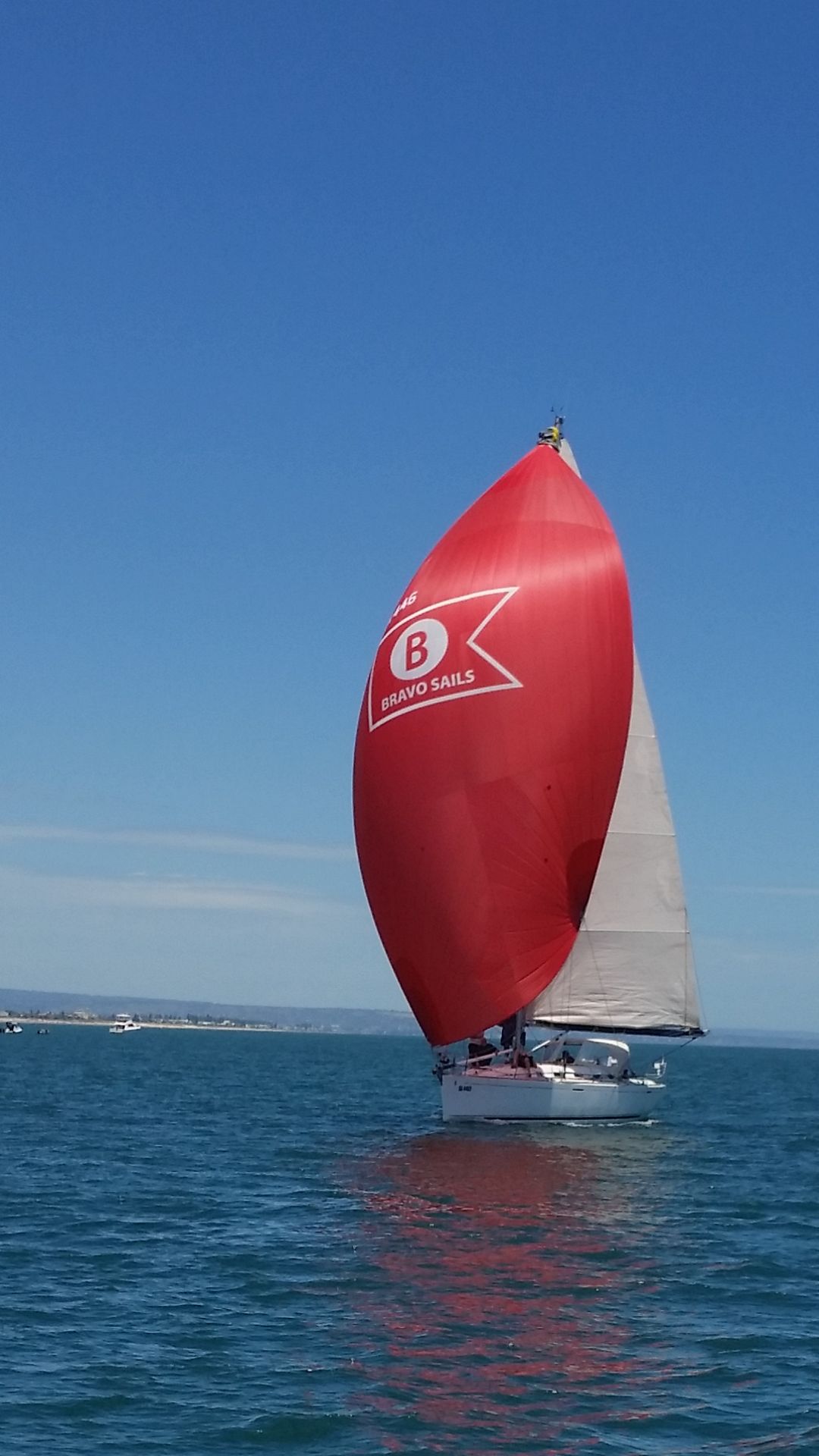 Yacht sailing with a red Bravo Sails spinnaker
