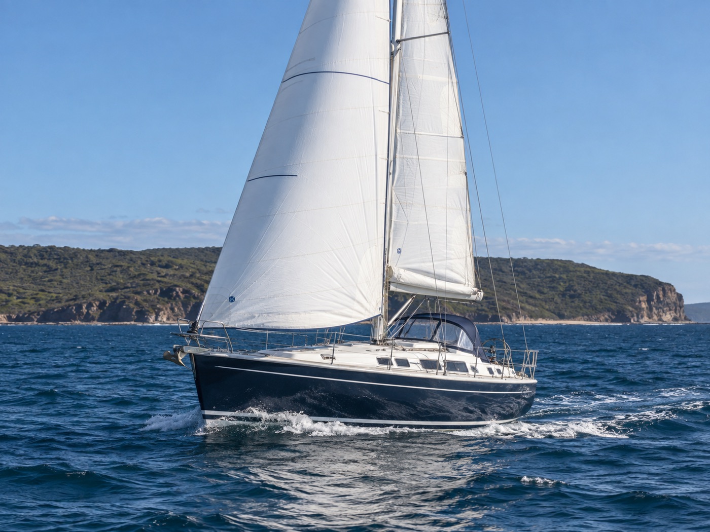 Cruising yacht sailing with a white roller-furling genoa